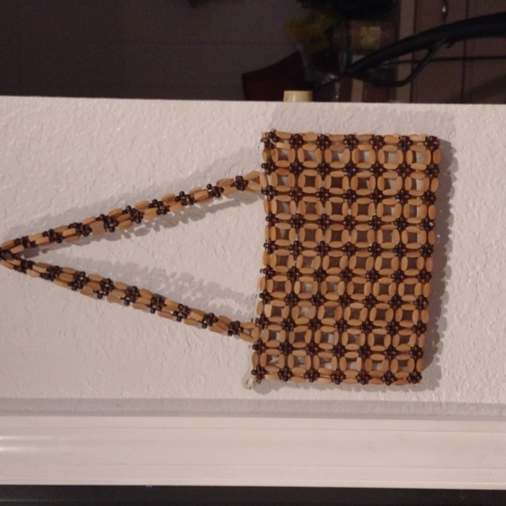 A small tan and brown beaded purse